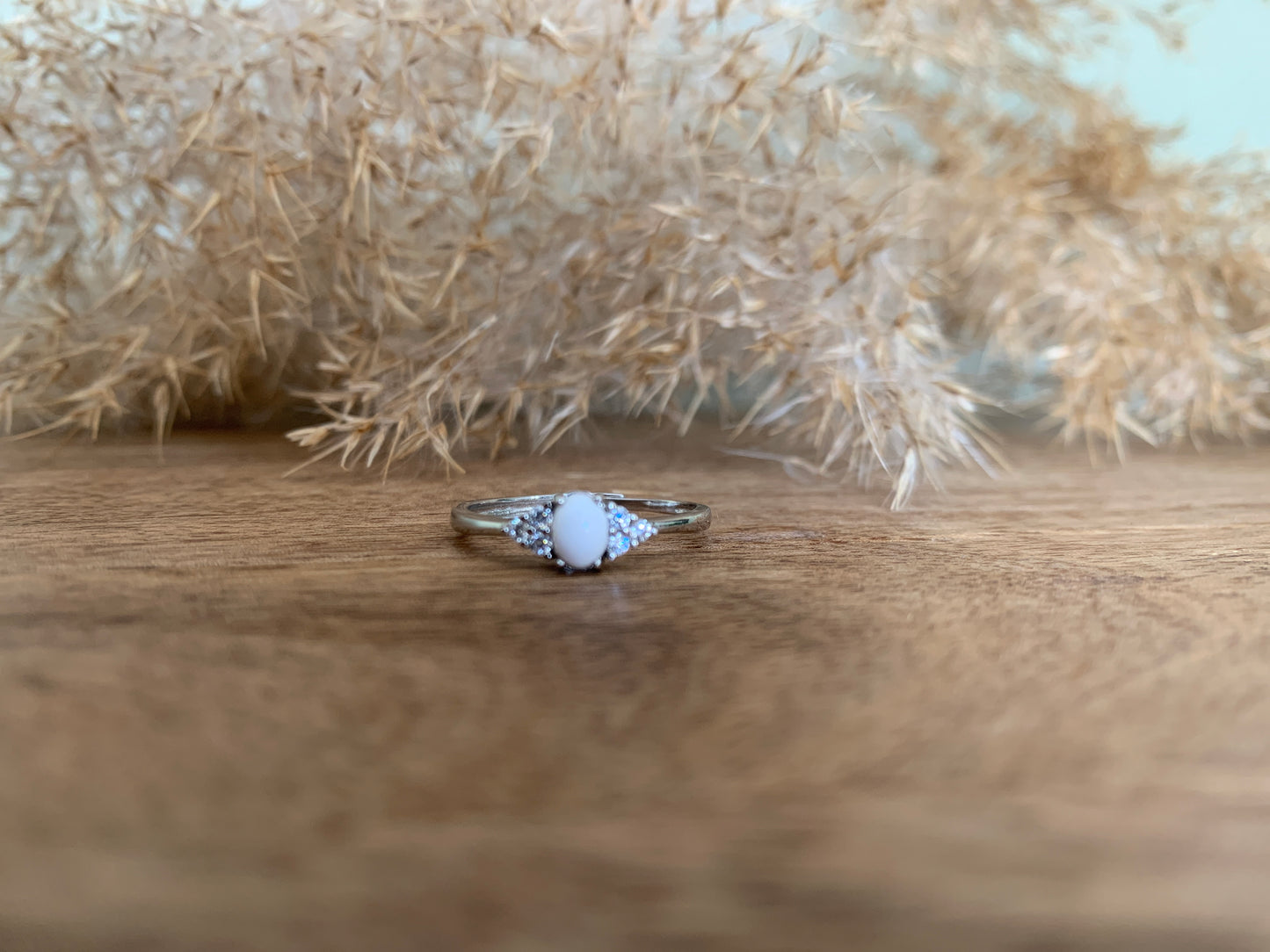 Sterling Silver Breastmilk Ring with 4x6 Oval Centre Inclusion. Surrounded by Cubic Zirconia stones (3) on each side.